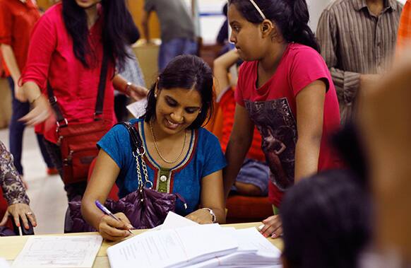 Indians send telegrams on the last day of the 163-year-old service at the central telegraph office in Mumbai.