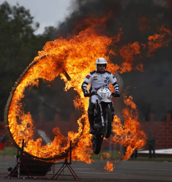 An Indian army soldier on a motorcycle performs a stunt during a display held as part of the sixtieth anniversary celebrations of the Military College of Electronics and Engineering in Hyderabad.