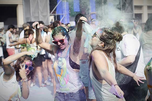Visitors of the Holi Festival of Colours throw special colored powders in the air in Barcelona, Spain.