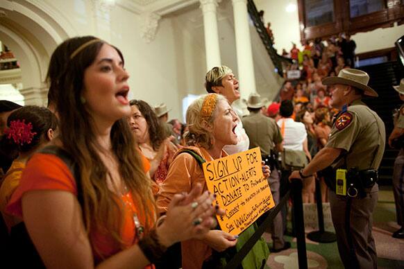 Abortion rights advocates voice their opposition to HB2 from the area outside of the Senate Chamber in the State Capitol in Austin, Texas.