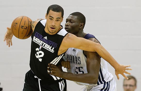 Sacramento Kings Drew Gordon, left, tries to drive around Dallas Mavericks Hamady N`Diaye, right, in the second quarter of an NBA Summer League basketball game in Las Vegas.