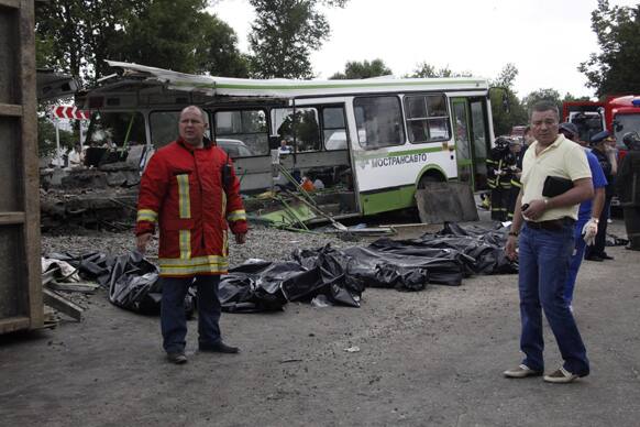 Bags containing victims of a crash involving a bus and a truck are laid at the site of the crash near Oznobishino, a settlement in the Moscow, Russia. Fourteen people are dead after a truck carrying concrete ran into a passenger bus in an outlying area of Moscow.