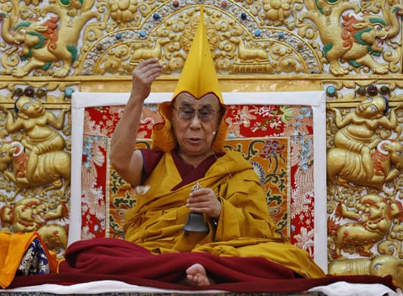Tibetan spiritual leader the Dalai Lama wears a traditional religious cap as he delivers a sermon during an initiation for Buddhist monks at the Dzongar Chodhe Monastery in Gurupura 210 kilometers (131 miles) southwest of Bangalore.