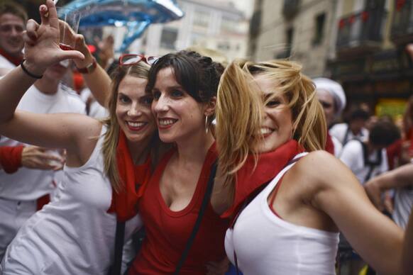 Revelers enjoy the day after leave the bull ring, at the San Fermin festival, in Pamplona northern Spain. Revelers from around the world arrive in Pamplona every year to take part in some of the eight days of the running of the bulls glorified by Ernest Hemingway`s 1926 novel
