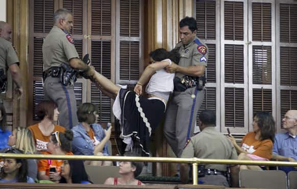 DPS troopers arrest a woman in the Senate Chamber at the Capitol in Austin, Texas, during the abortion debate.