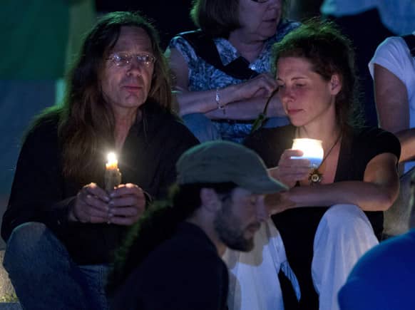 People gather in front of the St-Agnes church during a vigil for the victims of the train crash in Lac-Megantic, Quebec.