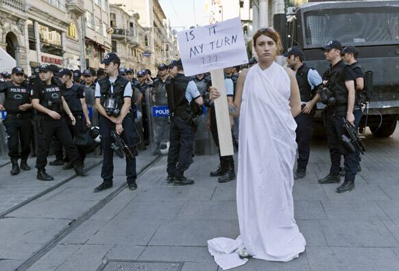 A member of a gay community stands in front of a line of riot police during a protest against the killing of Dora Oezer, a transsexual Turkish woman, who according to local media was killed this week in Kusadasi, in Istanbul.