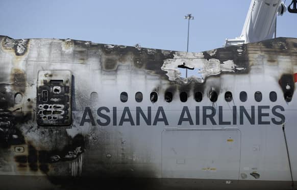 The wreckage of Asiana Flight 214, which crashed on Saturday, July 6, 2013, seen at San Francisco International Airport, in San Francisco.