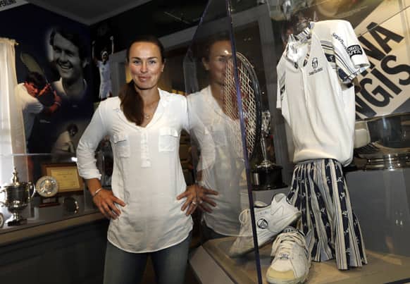 Tennis great Martina Hingis of Switzerland poses near a display dedicated to her career at the International Hall of Fame Museum.