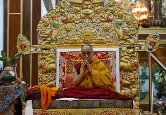 Tibetan spiritual leader the Dalai Lama gestures before delivering a sermon during a religious congregation at the Dzongar Chodhe Monastery in Gurupura, 210 kilometers (131 miles) southwest of Bangalore.