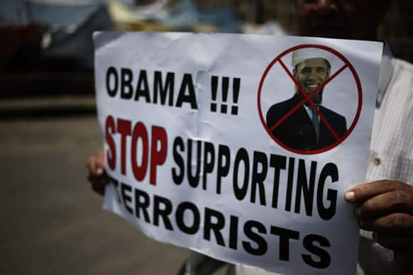 An opponent of ousted Egypt`s Islamist President Mohammed Morsi shows a banner in Tahrir square, in Cairo, Egypt. The unseating of Morsi followed demonstrations by millions of Egyptians against his rule.