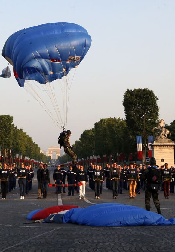 A French paratroopers land on Concorde Plaza during a rehearsal of The French Bastille Day or National Day at the Champs-Elysees avenue in Paris.