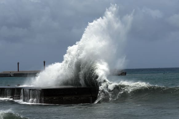 Massive waves from the winds of approaching Typhoon Soulik break on the harbor in Toucheng, Taiwan. Taiwan is closing schools and deploying soldiers to help with evacuations Friday as Typhoon Soulik threatens to bring strong winds and heavy rains to the island.