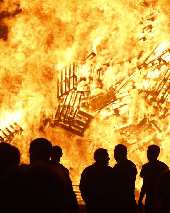 Loyalists attend a bonfire in the Sandy Row area of Belfast, Northern Ireland. Hundreds of fires were set alight Thursday as loyalists celebrate the July 12, remembering the defeat of the Catholic King James, by the Protestant William of Orange in 1690.