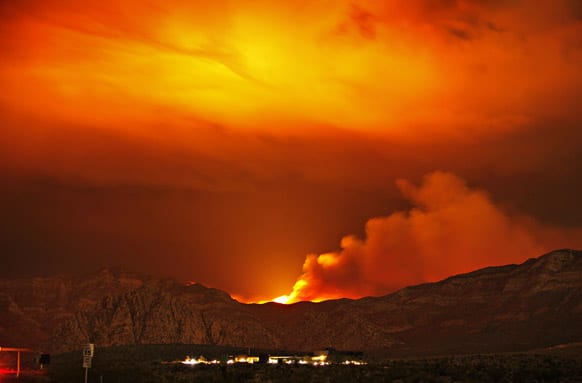 The Carpenter 1 fire burns in the mountains behind the Red Rock Conservation Area visitor center near Las Vegas.