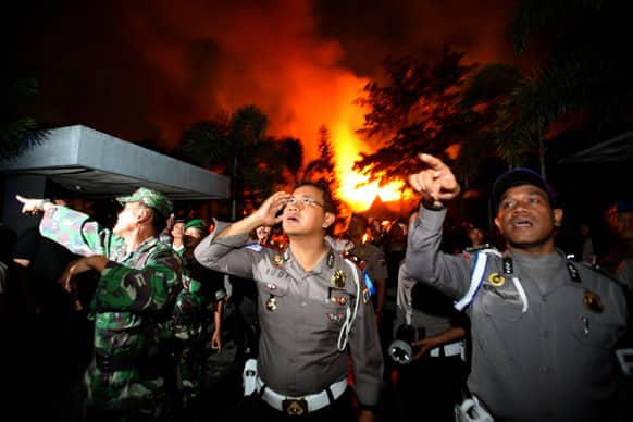 Police officers and soldiers give orders to others as they are deployed outside Tanjung Gusta prison that was partially set ablaze by inmates during a prison riot in Medan, North Sumatra, Indonesia.