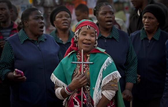 Traditional healer Dimakatso Matjele, center, who says she received instructions from her ancestors to go and pray for Nelson Mandela and so travelled to the hospital from her home in Qwa Qwa.