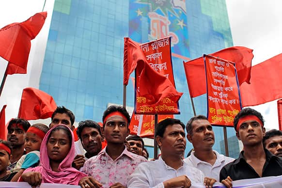 Bangladeshi garment workers participate in a protest outside the Bangladesh Garment Manufacturers and Export Association (BGMEA) office building in Dhaka, Bangladesh.