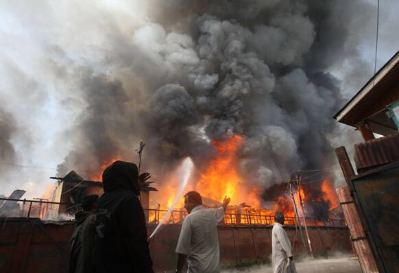Firefighters and civilians try to extinguish a fire at a government office building in Srinagar. A fire broke out in a building on the premises of the Civil Secretariat, the seat of the government of Jammu and Kashmir.