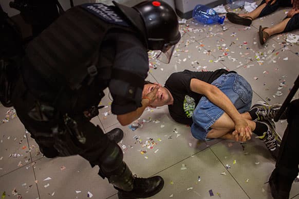 An activist of Mortgage Victims` Platform (PAH) argues with a riot police officer after occupying a bank as part of a protest to support a neighbor who is facing an eviction process in Barcelona, Spain.