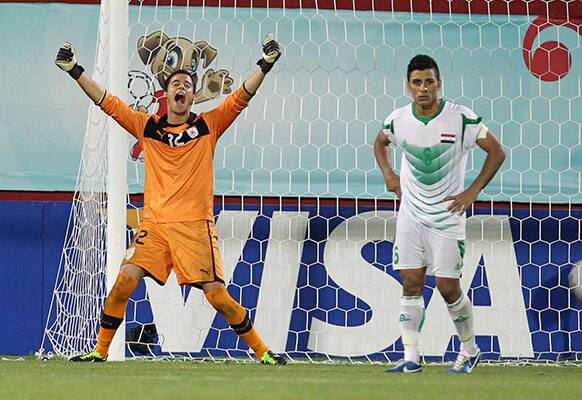 Iraq`s Saif Salman, right, reacts after he missed the last penalty of his team as Uruguay`s goalkeeper Guillermo De Amores celebrates during an Under-20 World Cup semifinal soccer match at the Huseyin Avni Aker stadium in Trabzon, Turkey.