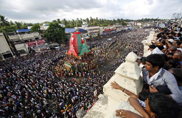 Devotees stand on rooftops to watch the annual Rath Yatra or chariot procession in Puri, 60 kilometers (37 miles) from the eastern Indian city of Bhubaneswar.