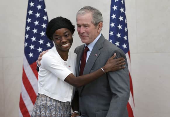 Former President George W. Bush posses for a photo with Mondell Bernadette Avril after she was sworn in as a U.S. citizen during a ceremony at the The George W. Bush Presidential Center in Dallas. Twenty new citizens took the oath of US citizenship at the former president`s library.