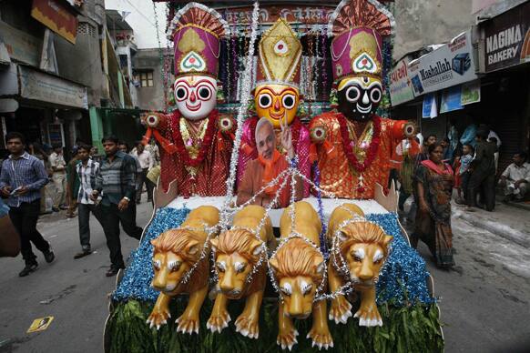 A cut out photograph of Gujarat state Chief Minister Narendra Modi is placed on a tableau as devotees pass by it during the annual chariot procession of Hindu god Lord Jagannath in Ahmadabad.