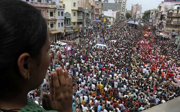 A woman worships as thousands of devotees participate in the annual chariot procession of Hindu god Lord Jagannath in Ahmadabad.