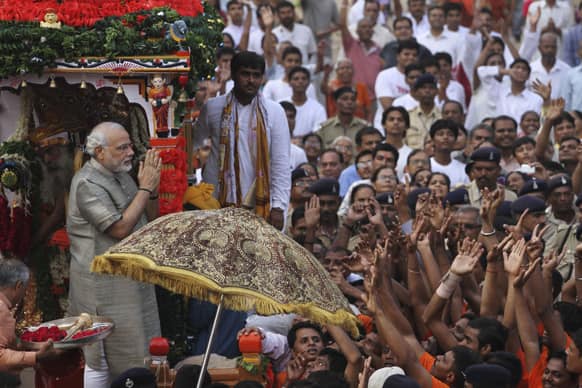 Gujarat state Chief Minister Narendra Modi greets devotees during the annual chariot procession of Hindu god Lord Jagannath in Ahmadabad.