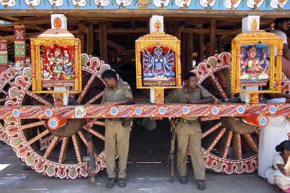Policemen stand guard near a chariot meant for the annual Rath Yatra or Chariot procession of Lord Jagannath in Puri, 60 kilometers (37 miles) from the eastern Indian city of Bhubaneswar.