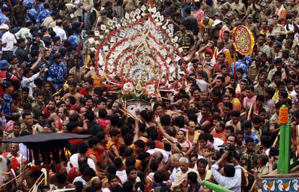 FILE PHOTO: Hindu devotees and temple priests gather around an idol of a Hindu God Balabhadra as they participate in the annual festival of Rath Yatra, or chariot procession, in Puri, Orissa.