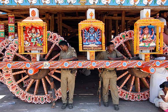 Indian policemen stand guard near a chariot meant for the annual Rath Yatra or Chariot procession of Lord Jagannath in Puri, 60 kilometers (37 miles) from the eastern Indian city of Bhubaneswar.