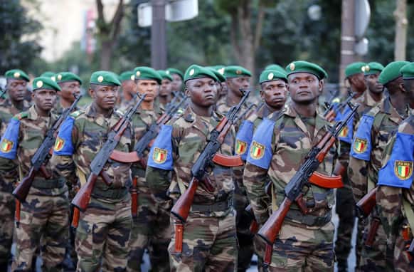 Army Forces of Mali stand by during the rehearsal of the French Bastille Day parade at the Champs-Elysees avenue in Paris.