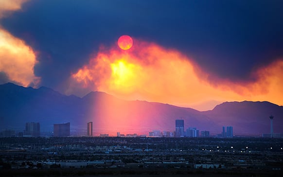 The Las Vegas Strip skyline is seen as smoke continues to billow from the Carpenter 1 fire on Mount Charleston in Las Vegas.