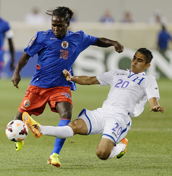 Honduras` Jorge Juarez, right, defends against Haiti`s Leonel Saint Preux during the first half of a CONCACAF Gold Cup soccer match, in Harrison.