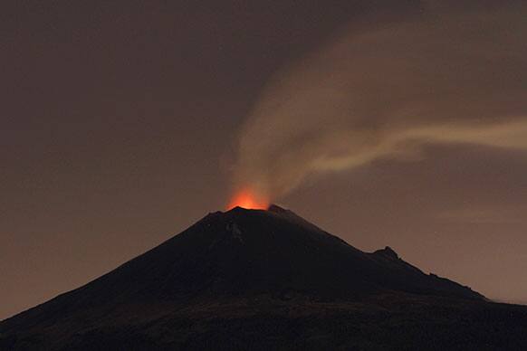Popocatepetl volcano spews lava, ash and steam during an eruption seen from from Santiago Xalitzintla, Mexico.