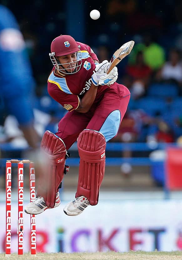 West Indies` Lendl Simmons jumps while trying to drive a wide delivery off Sri Lanka`s Lasith Malinga during their Tri-Nation Series cricket match in Port-of-Spain, Trinidad.