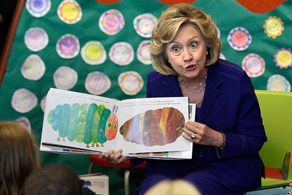 Former Secretary of State Hillary Rodham Clinton reads to children at a children`s library and learning center in Little Rock, Ark.