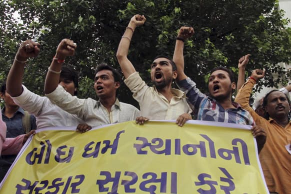 Activists of Hindu nationalist Vishwa Hindu Parishad, or World Hindu Council, hold a banner and shout slogans during a protest against a series of blasts in Bodh Gaya on Sunday, in Ahmadabad.