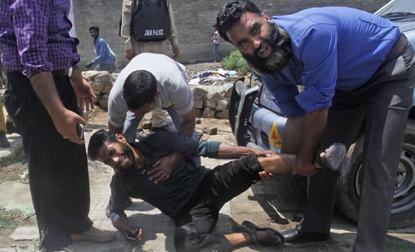 A Kashmiri government employee cries in pain after getting injured during a protest in Srinagar.