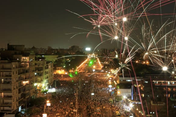 Fireworks burst over opponents of Egypt`s Islamist President Mohammed Morsi during a rally outside the Presidential palace in Cairo, Egypt.