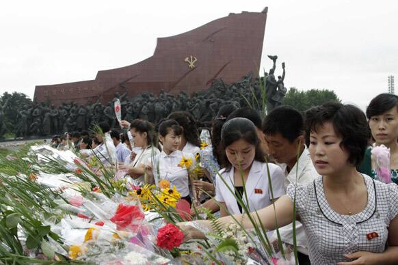 North Koreans lay flowers on Mansu Hill to show their respect to late North Korean leaders Kim Il Sung and Kim Jong Il on the 19th anniversary of Kim Il Sung`s death, in Pyongyang, North Korea.