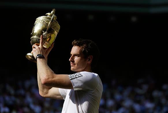 Andy Murray of Britain poses with the trophy after he defeated Novak Djokovic of Serbia in the Men`s singles final match at the All England Lawn Tennis Championships in Wimbledon.