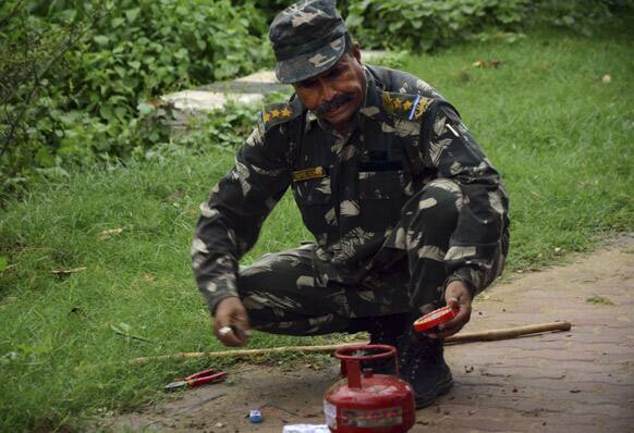 A bomb squad member defuses a suspected timer fitted device near a hotel in Bodhgaya, about 130 kilometers (80 miles) south of Patna, the capital of the eastern Indian state of Bihar.