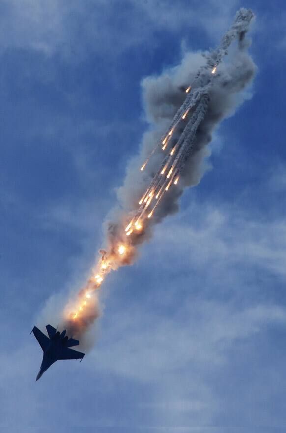 A Su-27 jet of aerobatics team Russkiye Vityasy or Russian Knights, releases decoys during the International Maritime Defense show in St. Petersburg, Russia.