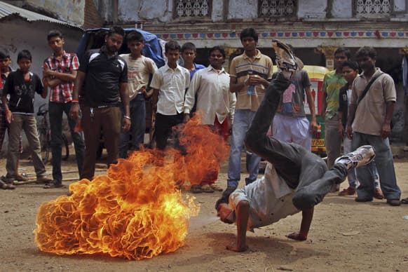 An Indian youth practices a fire stunt ahead of the annual Rath Yatra or Chariot procession of Lord Jagannath in Ahmadabad.