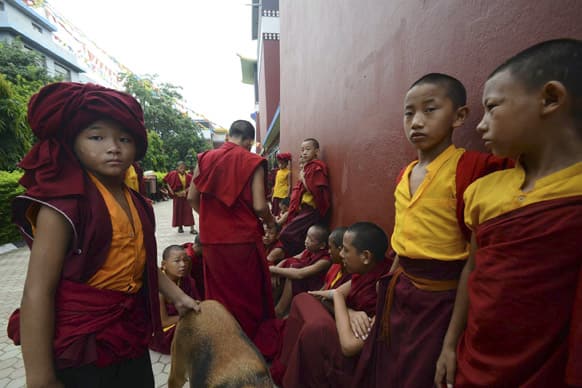 Novice Buddhist monks wait outside the Tergar Monastery, the site of an explosion, in Bodhgaya, about 130 kilometers (80 miles) south of Patna, the capital of the eastern Indian state of Bihar.