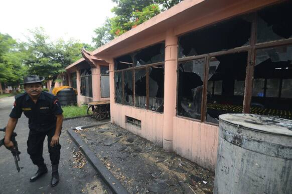 A security officer inspects the site of an explosion on the campus of the Mahabodhi Temple, the Buddhist Great Awakening temple, in Bodhgaya.