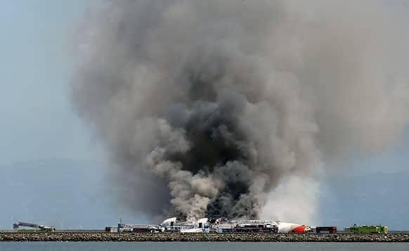 Smokes rises from Asiana Flight 214 after it crashed at San Francisco International Airport in San Francisco.